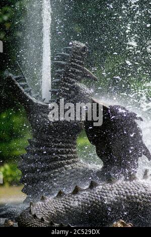 25 June 2020, Saxony-Anhalt, Ballenstedt: The dragon in the large water basin of the Ballenstedt castle garden spits up a water fountain. The castle garden is one of the most important gardens in Saxony-Anhalt and covers 29 hectares. The park goes back to Prince Friedrich Albrecht of Anhalt-Bernburg who made Ballenstedt his residence in 1765. Ballenstedt Castle and Castle Park is part of the network 'Garden Dreams - Historical Parks in Saxony-Anhalt' which wanted to celebrate its 20th anniversary this year. It comprises 43 of the most important and beautiful gardens in the state. Due to the sp Stock Photo