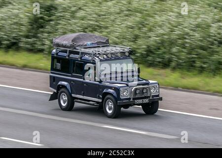 Land Rover Defender 110 County Td5 4x4 Blue LCV Diesel driving on the M6 motorway near Preston in Lancashire, UK Stock Photo