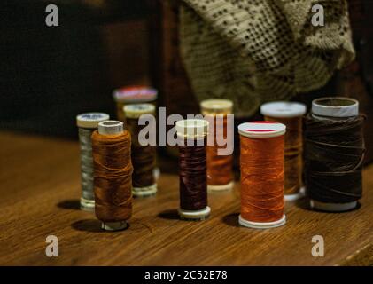 Lot of colorful yarn rolls on the table in a tailor's studio Stock Photo