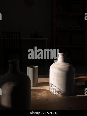 Three vases on a table in the sunlight Stock Photo