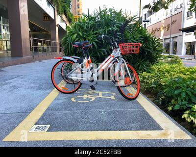 SINGAPORE, SINGAPORE - Jun 09, 2020: Parking space for rent bicycles in Singapore . Yellow marks on the floor. Stock Photo