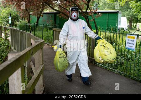 A city council worker carries rubbish from a coronavirus testing centre at Spinney Hill Park in Leicester, after the Health Secretary Matt Hancock imposed a local lockdown following a spike in coronavirus cases in the city. Stock Photo