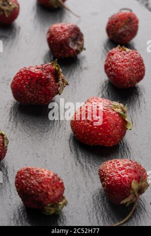 spoiled strawberry flat lay. Ironic market food photos. stale foods can be beautiful. vertical photo. Stock Photo