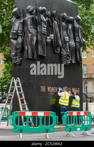 London 30th June 2020 Workers clean the memorial to 'Women of World War II' in Westminster London Credit: Ian Davidson/Alamy Live News Stock Photo