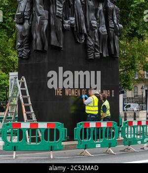London 30th June 2020 Workers clean the memorial to 'Women of World War II' in Westminster London Credit: Ian Davidson/Alamy Live News Stock Photo