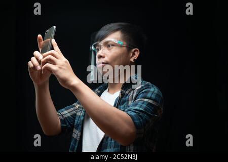 Man wearing a face mask taking a selfie Stock Photo