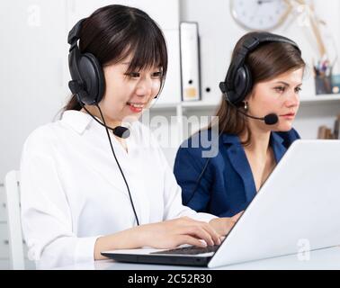Operators working with computers in an office Stock Photo