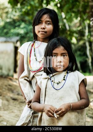 COLOMBIA South America People Kogi family sitting outside mud brick ...