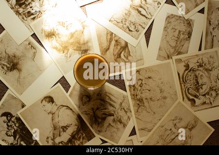 Old postcards are scattered in a chaotic manner and a cup lies on them Stock Photo