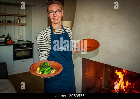 Dinner in your own four walls. The fireplace is burning and the main course can be put in the oven abroad. Ferme du Vent near Château Richeux, Saint-Malo, France Stock Photo