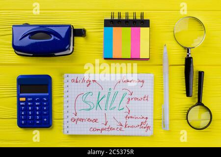 Notepad with skill word and stationery items. Stock Photo