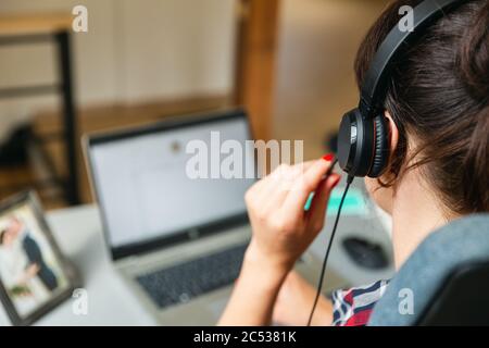 Bautifull women on a conforence call in home office. Working from home. Stock Photo