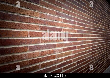 Rust colored brick wall with leading lines, texture and vignette. Stock Photo