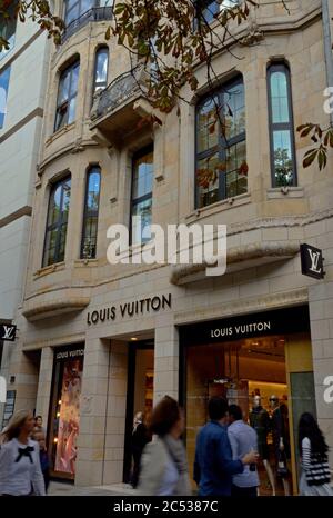 dusseldorf, germany - august 25, 2012: people passing by a louis vuitton boutique on konigsalle in dusseldorf Stock Photo