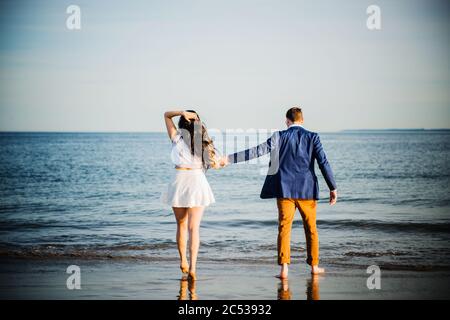 young couple walking on the beach Stock Photo