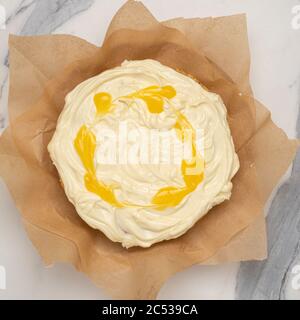 Plan view of a home baked parsnsip cake with cream cheese frosting with lemon curd swirls. Stock Photo