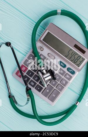Green stethoscope on calculator. Stock Photo