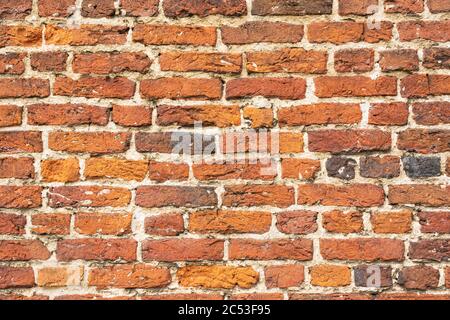 Wall with old worn vintage bricks Stock Photo