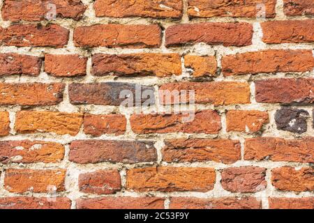 Wall with old worn vintage bricks Stock Photo