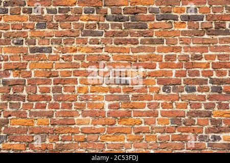 Wall with old worn vintage bricks Stock Photo