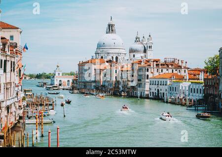 Venice, Italy. Daily boat and tourist hectic on Grand Canal and Basilica Santa Maria della Salute. Stock Photo