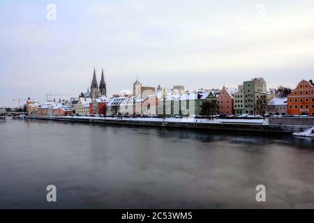 Regensburg, Upper Palatinate, Bavaria, Germany, banks of the Danube in winter with Regensburg Cathedral and town hall tower. The old town is an UNESCO Stock Photo