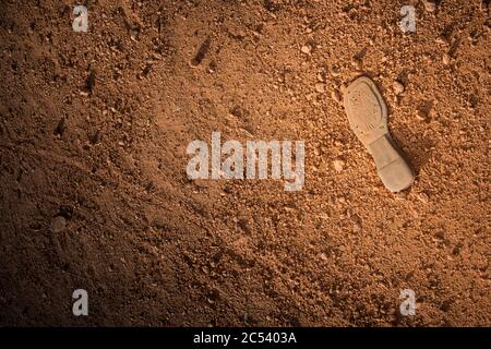old shoe sole lies on red sandy bottom Stock Photo