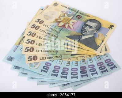 Many 100 and 50 RON or lei romanian banknotes on white background. Romanian currency. Stock Photo