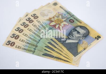 Many 50 RON or lei romanian banknotes on white background. Romanian currency. Stock Photo