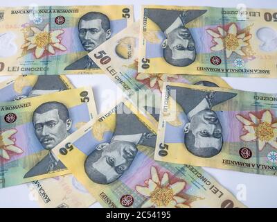 Many 50 RON or lei romanian banknotes on white background. Romanian currency. Stock Photo