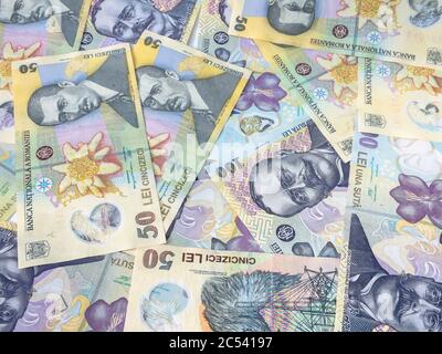 Many 500, 100 and 50 RON or lei romanian banknotes on white background. Romanian currency. Stock Photo