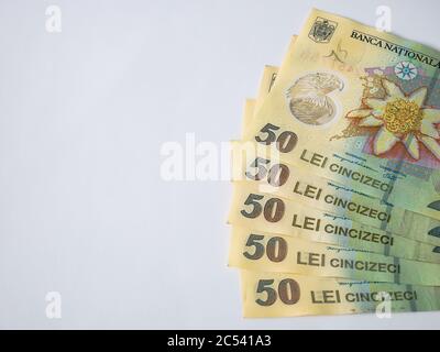 Many 50 RON or lei romanian banknotes on white background. Romanian currency. Stock Photo