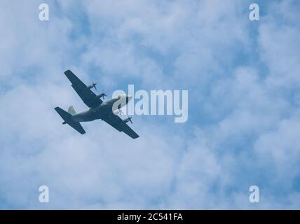 Large military cargo plane flying over Bucharest. Plane prepairing for landing. Stock Photo