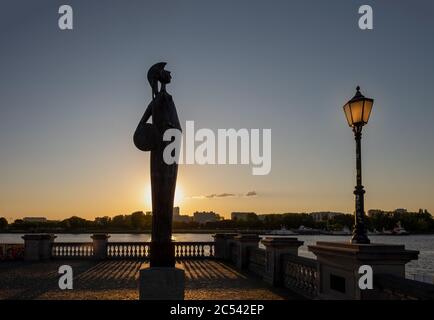 Silhouette of the Minerva Statue and a lamp post in the center of Antwerp, Belgium. Minerva was the Roman Goddess of wisdom and strategic warfare. Stock Photo