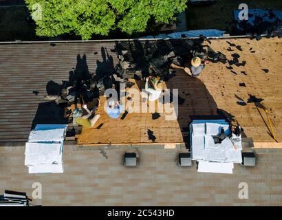 Roofer repair replace shingle that has been damaged and needing replacement Stock Photo