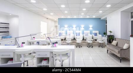 Moscow – Feb 7, 2019: Nail salon bright interior. Panoramic view of a modern manicure salon. Inside a beauty studio with white design. Stock Photo