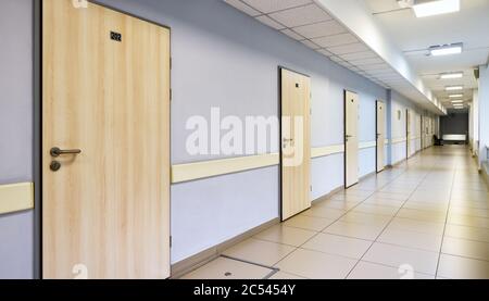 A long corridor with many doors in the office or clinic Stock Photo