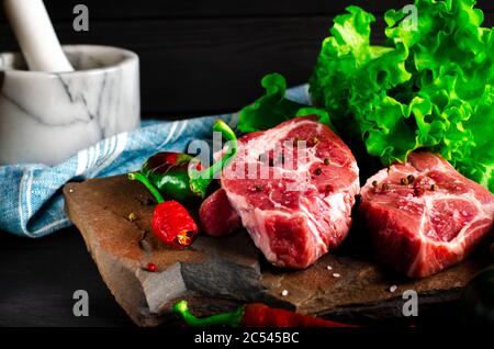 Raw meat beef marble steak with spices and vegetables Stock Photo