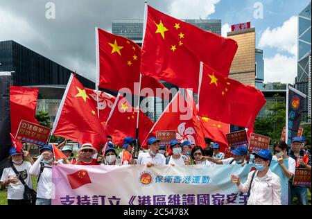 Pro-China supporters rally and celebrate with flags at Tamar Park hours after Chinese government and Hong Kong Chief Executive Carrie Lam passed the National Security Law in Hong Kong. Stock Photo