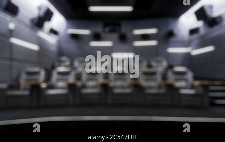 Small empty cinema hall as creative abstract blur background. Inside the dark comfortable theatre. Contemporary luxury cinema auditorium design. Panor Stock Photo