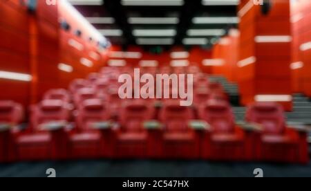 Panoramic view of an empty cinema hall as creative abstract blur background. Inside the red comfortable theatre. Contemporary cinema auditorium design Stock Photo