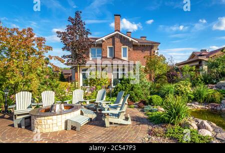 Moscow Region - Aug 24, 2019: Landscape design of home garden. Beautiful landscaping with small pond. Scenery of landscaped place with patio in summer Stock Photo