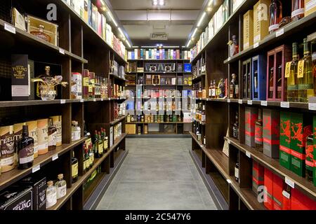 Moscow – Oct 6, 2019: Wine shop interior. Various wine bottles sale on wooden shelves in supermarket. Inside the luxury liquor store. Concept of alcoh Stock Photo
