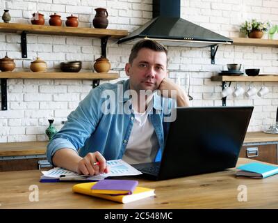 Remote work and self-employment. A businessman is working on a startup from home. Stock Photo