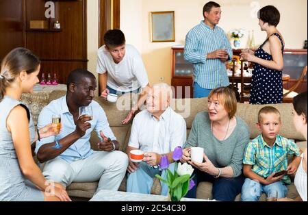 Portrait of big multigenerational family  chatting on sofa at home Stock Photo