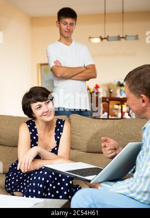 Woman with her teenage son meeting with real estate agent in her living room Stock Photo