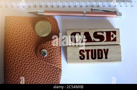 Case study words written on wooden blocks and wallet with pill of coins. Business statup successful examples concept Stock Photo