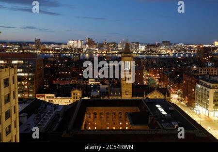 The night view of Back Bay neighborhood with bell tower of Old South Church and Boston Public Library in foreground and Charles River and Cambridge in background.Boston.Massachusetts.USA Stock Photo