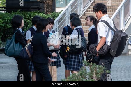 Japanese high school student at Shinagawa Station square, Tokyo, Japan. Stock Photo