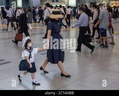 Japanese mother sending child to school in Shinagawa train stration, Tokyo, Japan Stock Photo